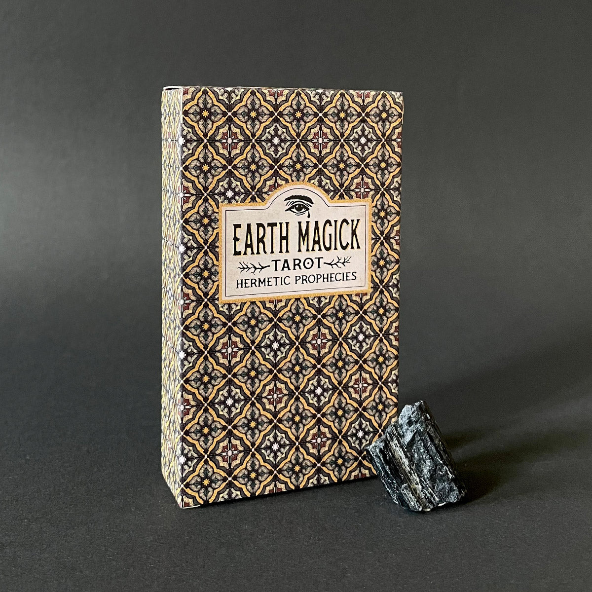 Earth Magick Tarot deck with decorative cover on a dark background
