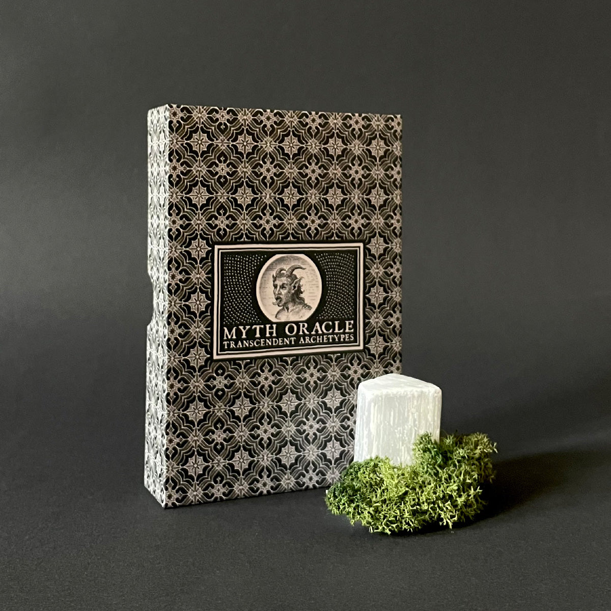 Myth Oracle deck with decorative cover on a dark background