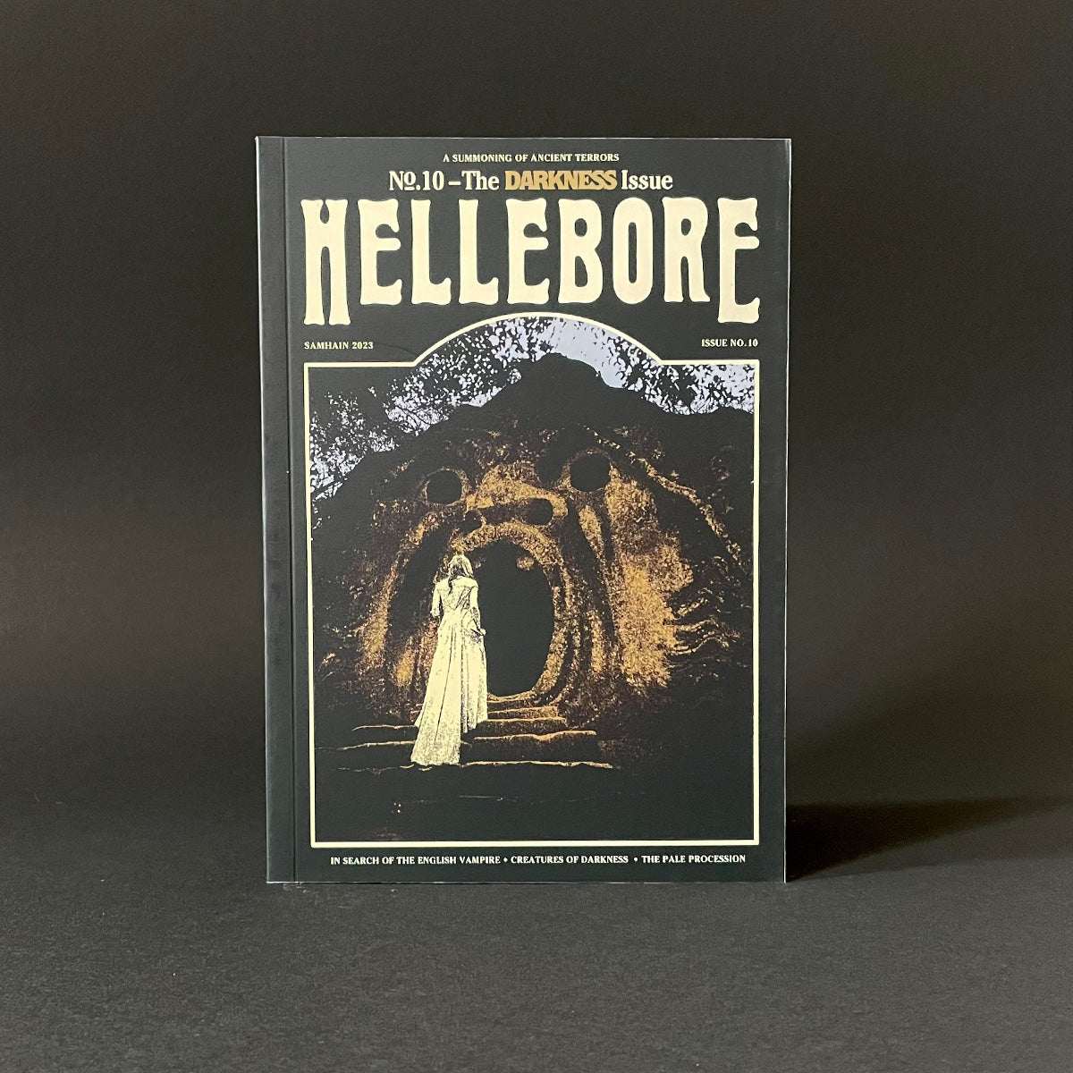 Book titled 'Hellebore' with a dark cover and illustration of a woman in a dress.