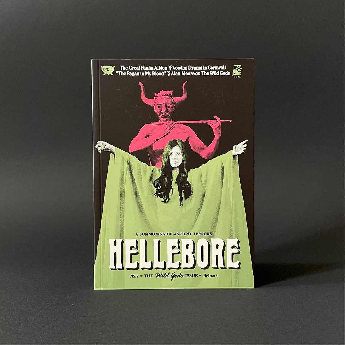 Book cover of 'Hellebore' with a red-figured figure and green fabric on a dark background
