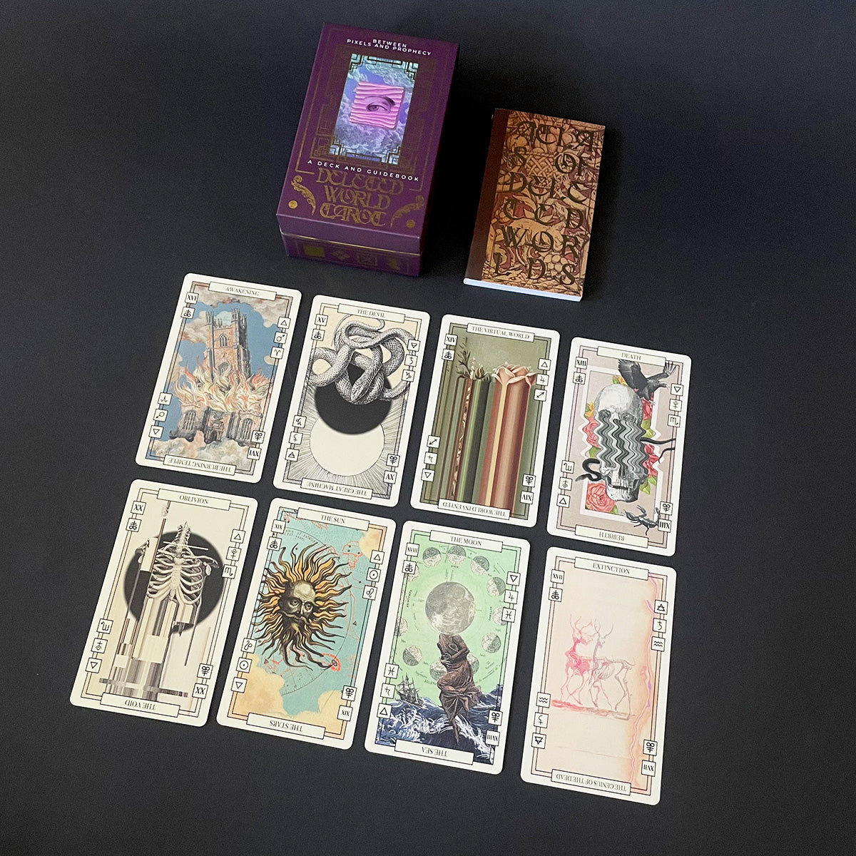 Collection of tarot cards and boxes on a dark surface