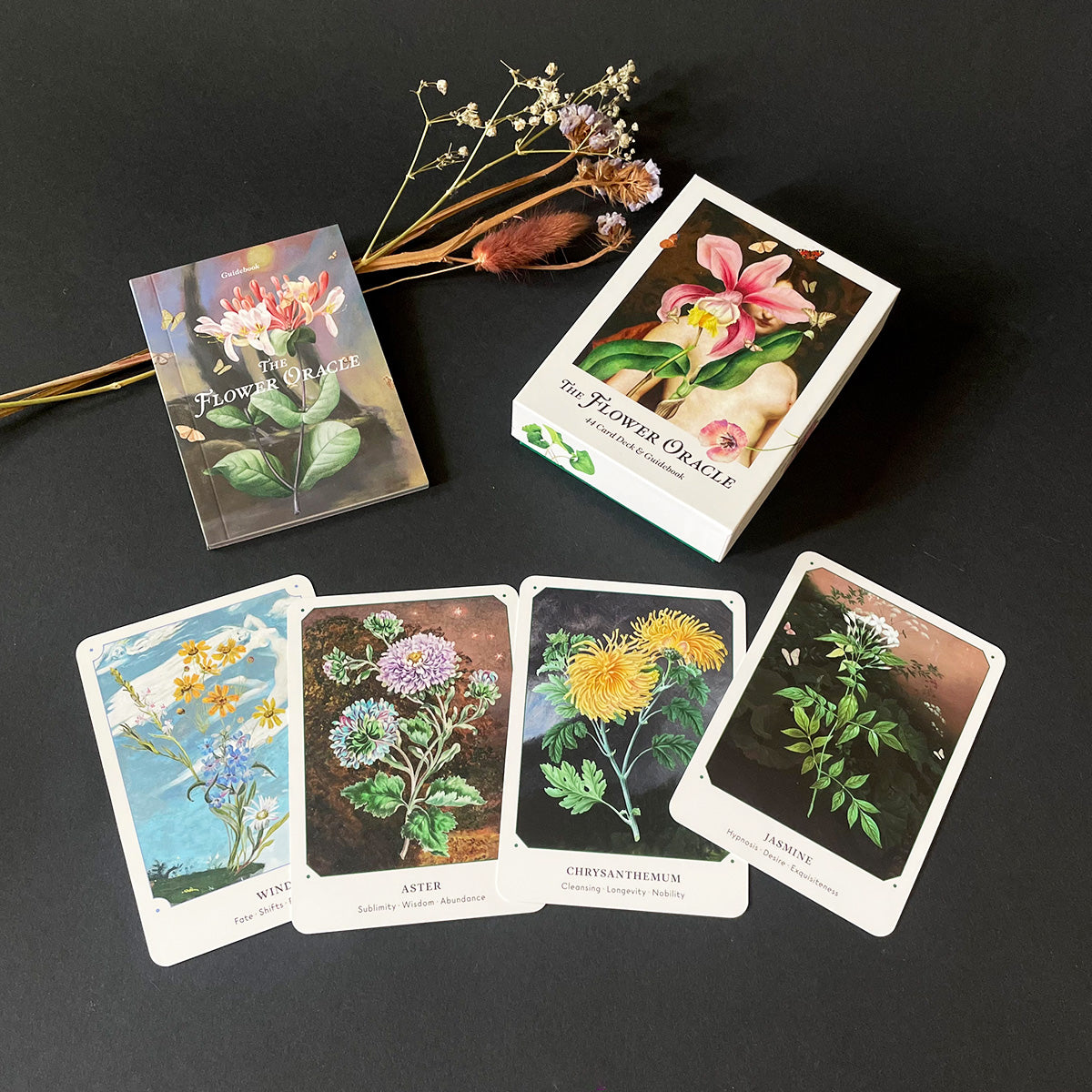 Flower oracle cards on a dark surface with decorative elements