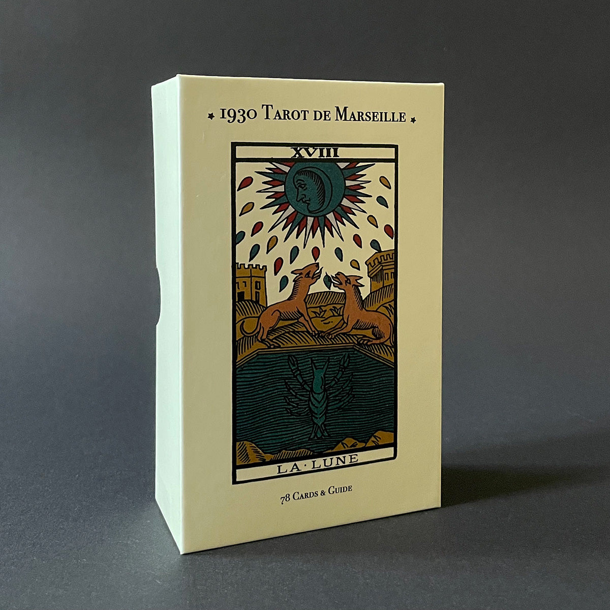 A boxed 1930 Tarot De Marseille deck with a graphic of a sun and stylized figures on the cover, indicating the Major Arcana.