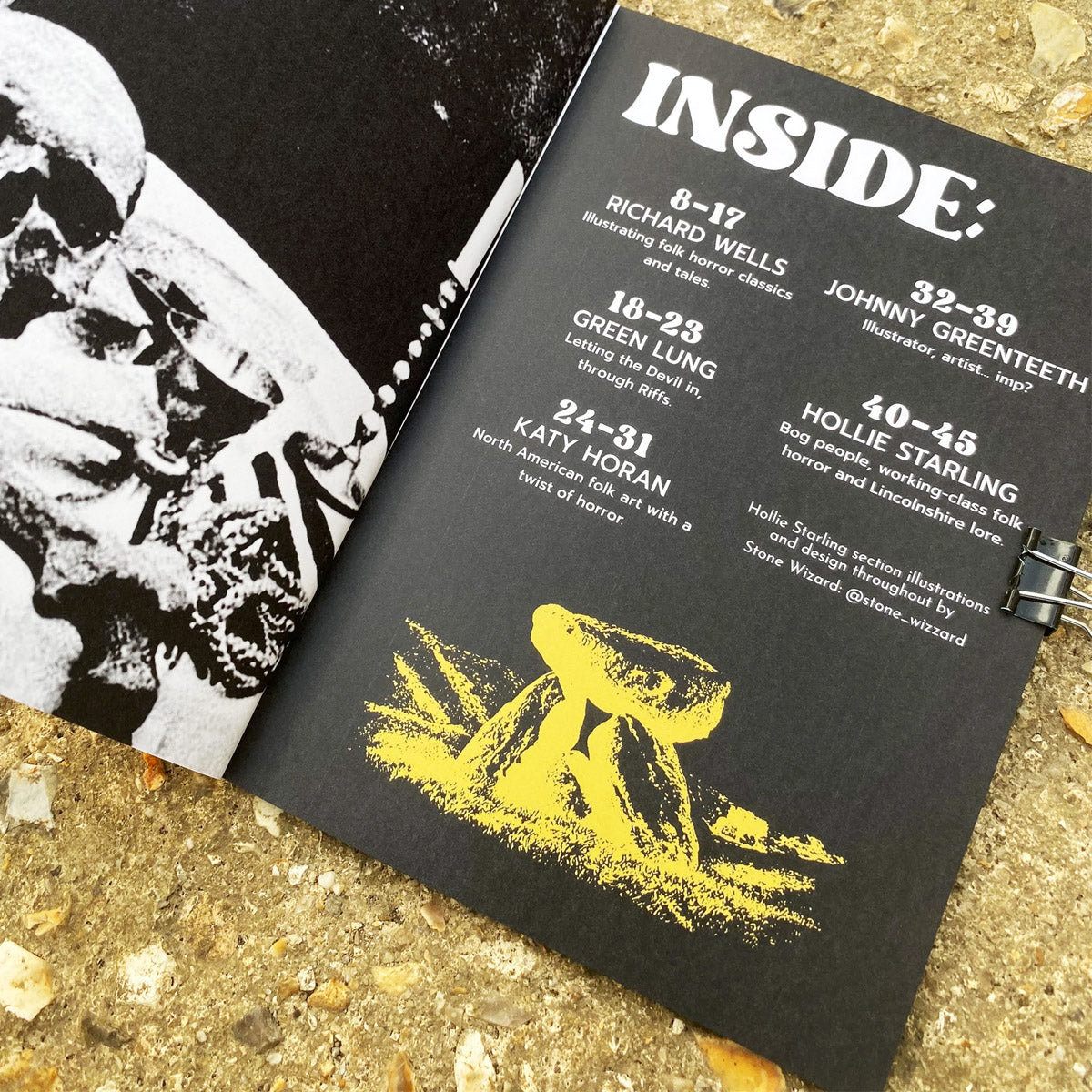 Black book with yellow illustration of a rock on a textured surface