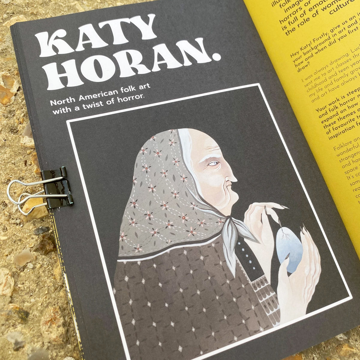 Magazine with article on 'Katy Horan' with illustration of a woman holding an egg on a textured surface.