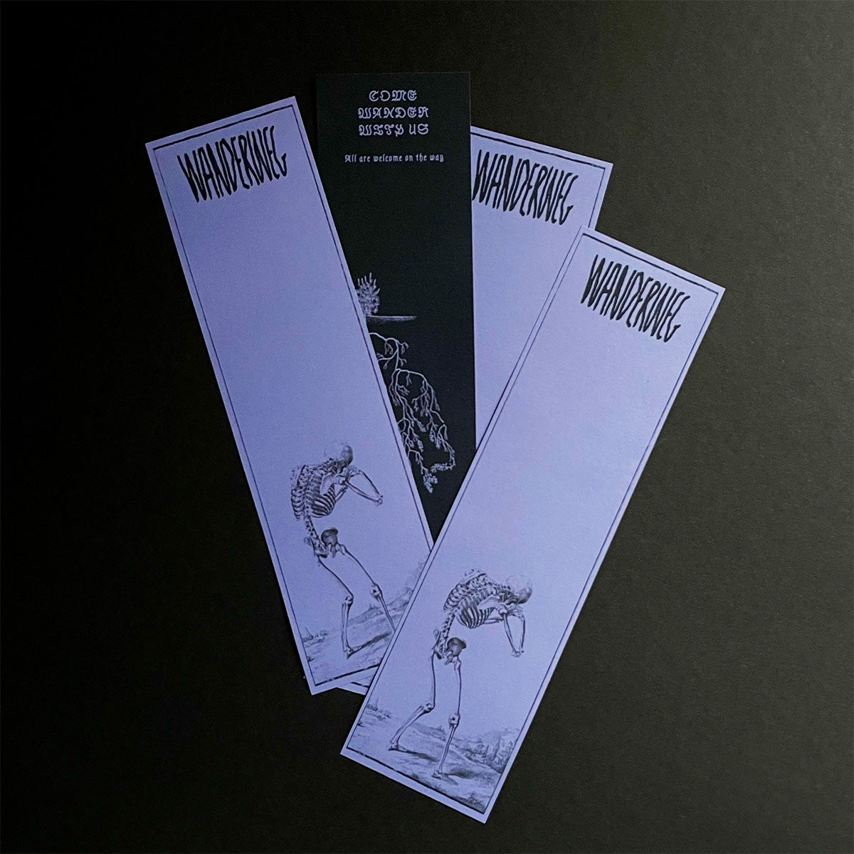 Four 'Wanderweg' bookmarks on a black background